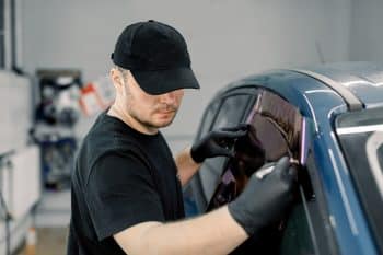 A window tint is applied by a techician that follows Alberta's tint laws