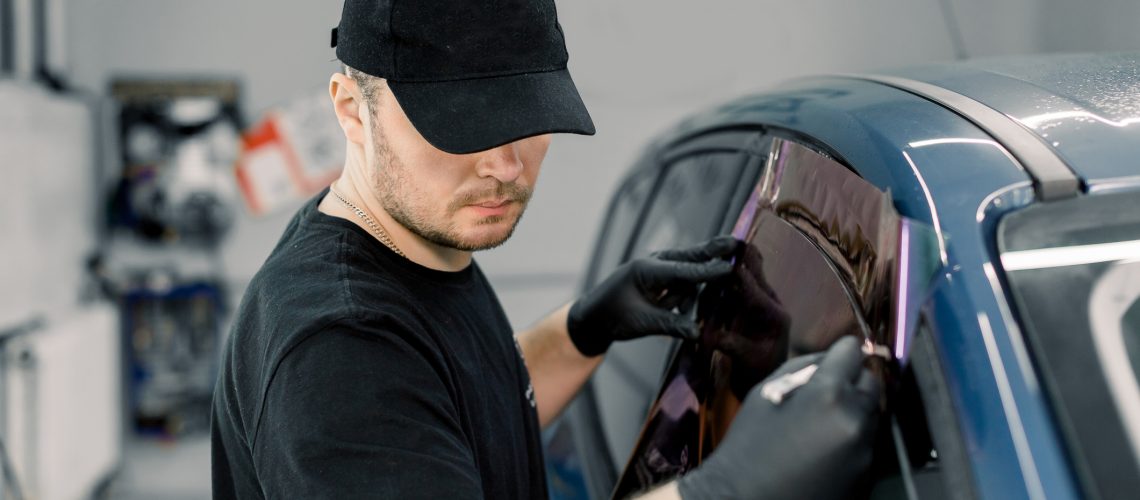 A window tint is applied by a techician that follows Alberta's tint laws